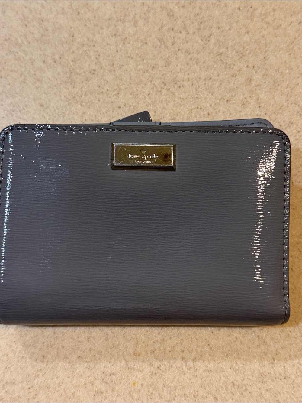 kate spade gray patent leather compact wallet with silver plaque